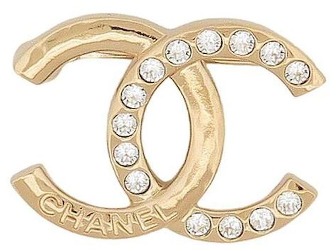 Spilla Chanel in metallo dorato champagne e strass D'oro
