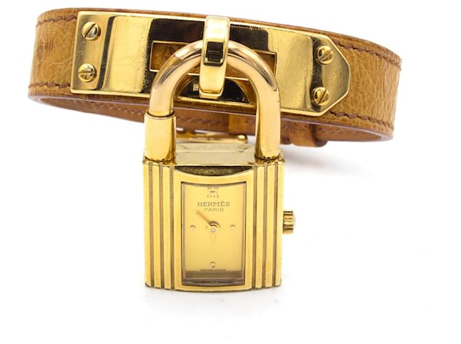 Montre Hermès Kelly dorée en cuir d'autruche 
