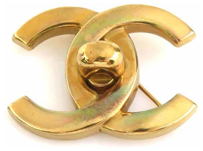 Broche de metal dorado Chanel Coco Mark