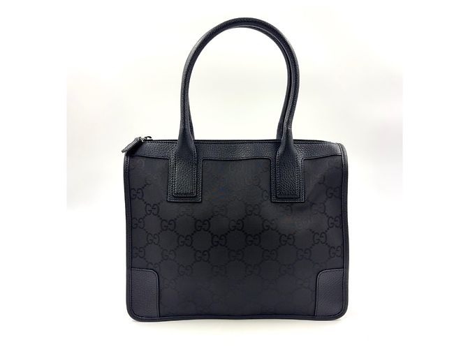 Bolsa de mão em couro e lona preta com padrão GG da GUCCI