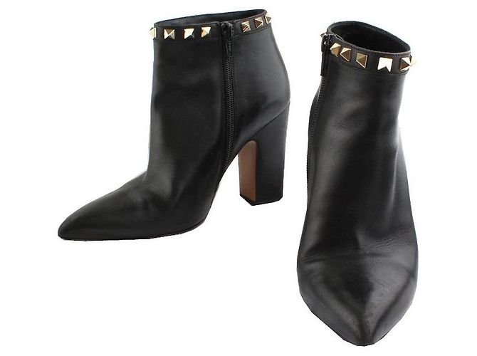 Valentino Botines Rockstud en oro negro