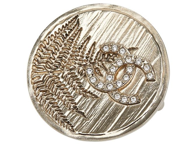 Broche de strass dorado Chanel Coco Mark