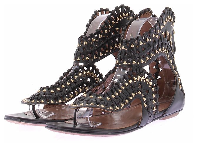 Alaïa Sandali piatti neri e dorati Nero