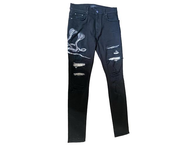 Jeans Amiri neri con serpenti e strappi Nero