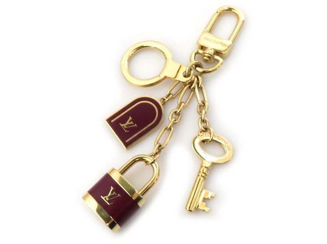 Chaveiro em forma de bolsa Hermès Dourado Bordeaux