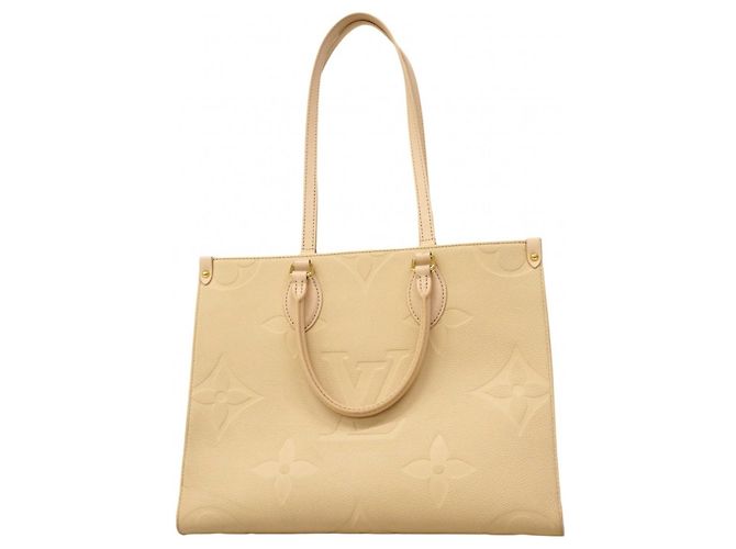 Sac tote OnTheGo MM en Monogram Empreinte de Louis Vuitton Écru