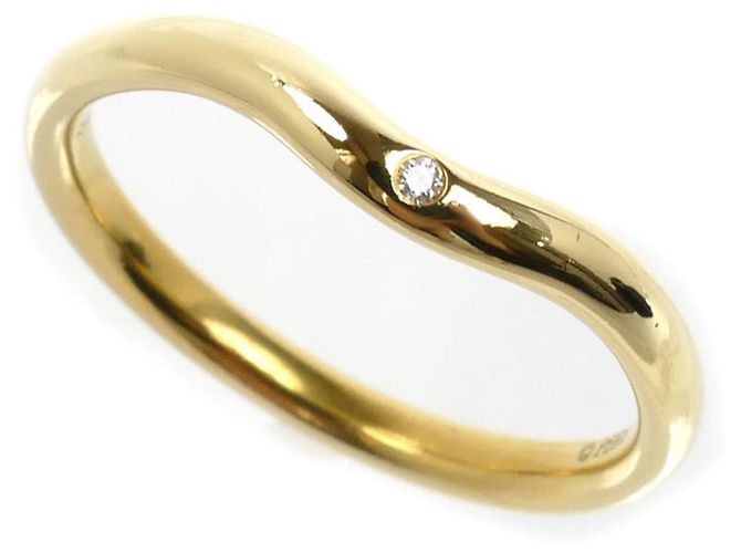 Anillo de banda curvada en oro amarillo de 18K con diamantes de Tiffany & Co.