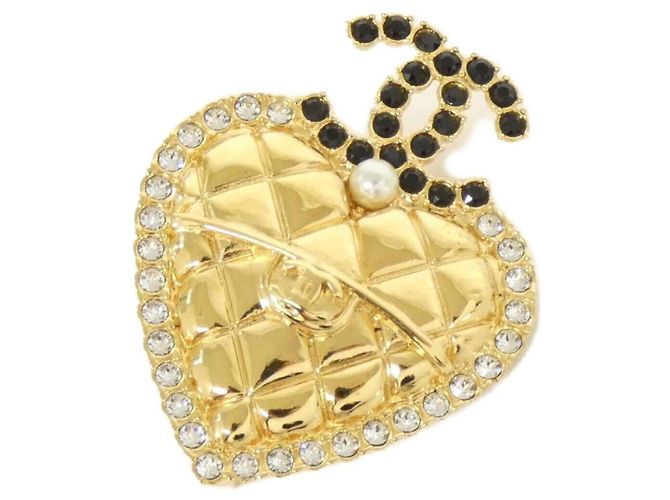 Spilla Chanel in nero, oro e bianco D'oro