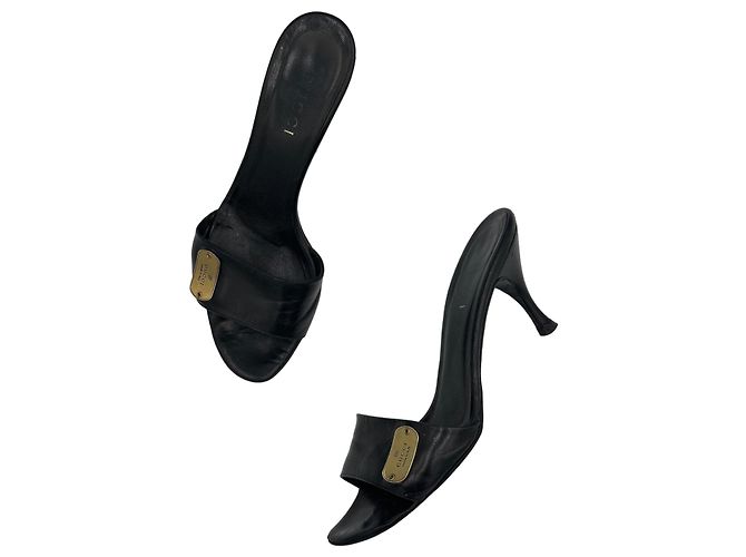 Gucci Leder Mules Schwarz mit Logo-Plakette