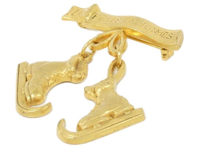 Broche Hermès dorado
