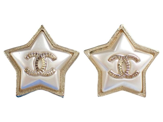 Boucles d'oreilles Chanel Star dorées argentées