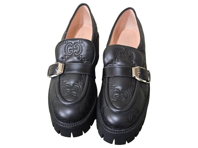 Gucci Plateauslipper aus schwarzem Leder mit GG-Monogramm