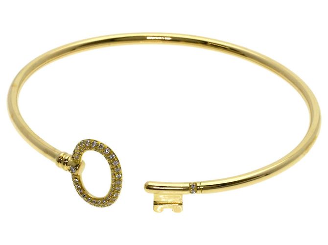 Pulsera rígida Tiffany & Co. de oro amarillo 18K con llave ovalada