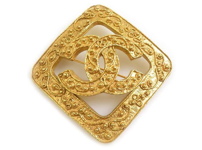 Broche de metal dourado Chanel