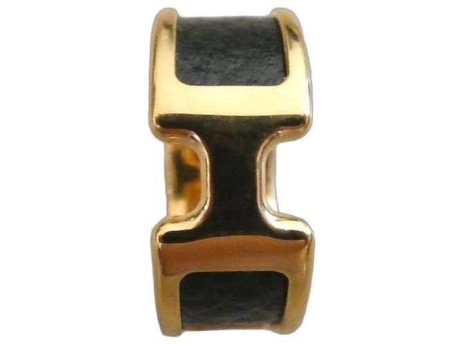 Anel Hermès Olympe H em aço dourado e couro preto