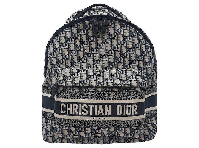 Christian Dior A travel backpack featuring Dior's iconic Oblique jacquard pattern. Made from waterproof technical canvas material, it offers a lighter weight than leather along with scratch-resistant durability. A