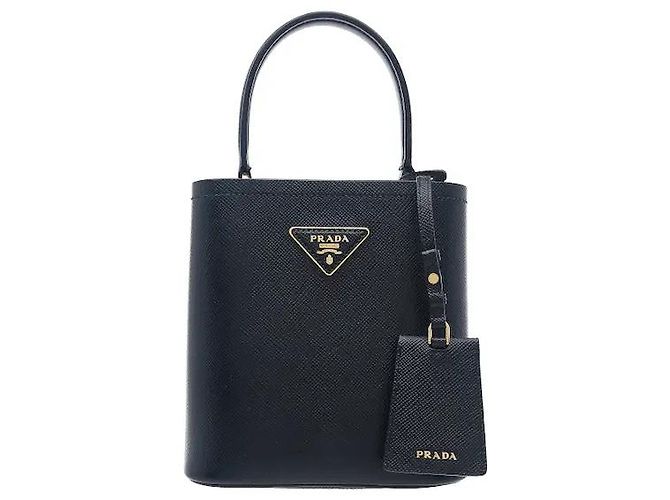Fabricado em couro Saffiano, este modelo apresenta durabilidade resistente a riscos e transmite a atmosfera distintamente sofisticada da Prada. A sua silhueta de mala bucket tridimensional é fácil de Preto