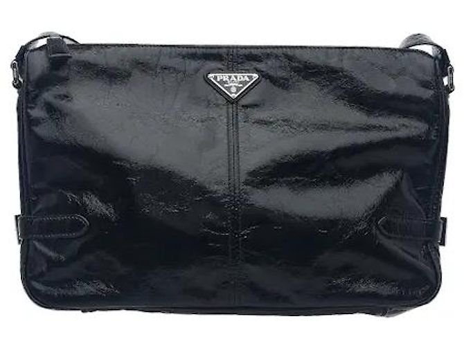 A leather shoulder bag showcasing smooth leather material and Prada's signature triangle logo. Its compact yet practical interior storage structure makes it easy to separately store belongings, and