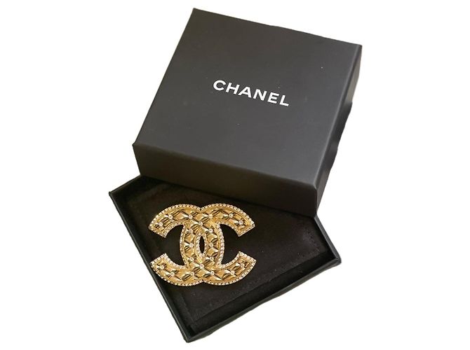 Broche Chanel CC dourada