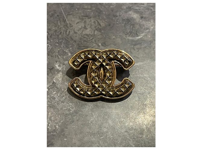 Broche Chanel dorada de metal Dorado