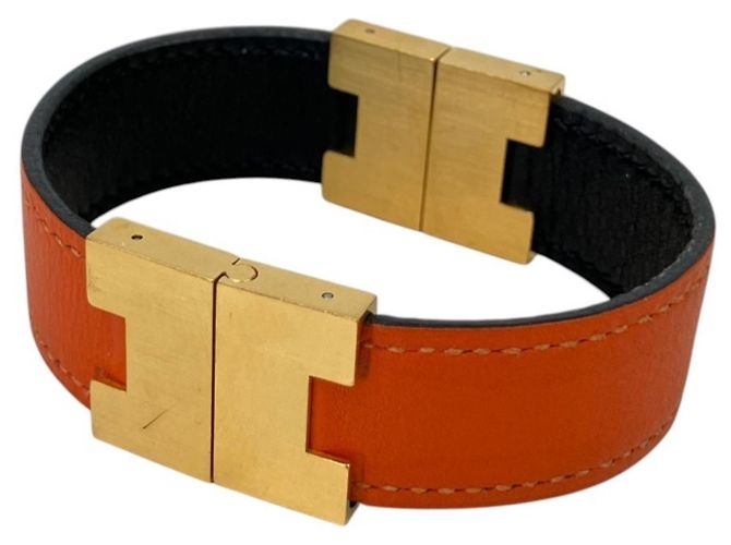 Hermès Pulsera de Dijes Reversible Hermes Roulie Negro Naranja
