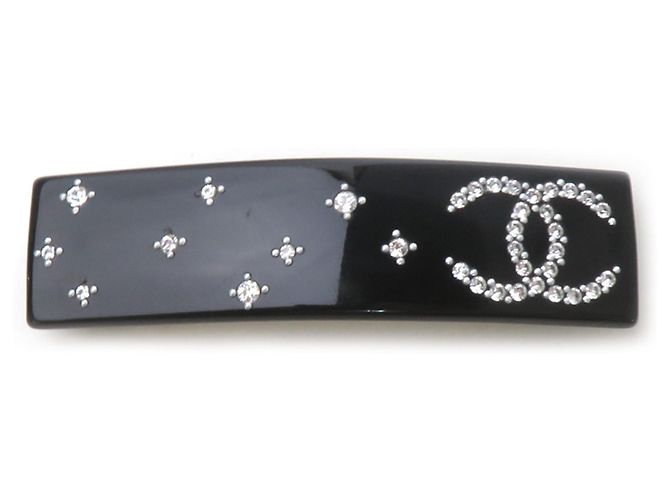 Fermi capelli Chanel in plastica nera Nero