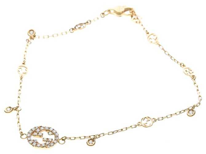 Bracciale con charm Interlocking Gucci in oro giallo 18K D'oro