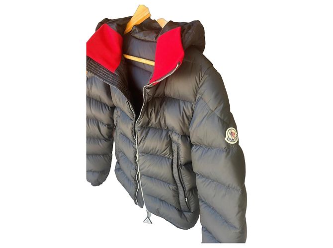 Black Moncler down jacket with red collar