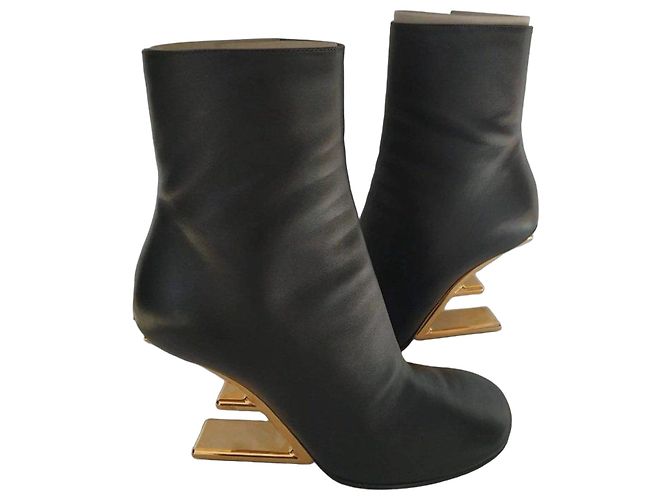 Fendi black leather ankle boots with gold heel.