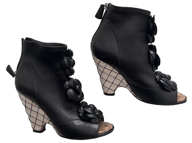 Chanel black leather ankle boots with camellia