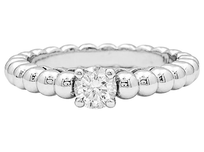 Bague solitaire Van Cleef & Arpels, "Perlée", or blanc et diamant.