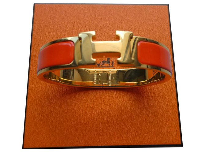 hermès clic H bracelet in golden steel and orange enamel worn once