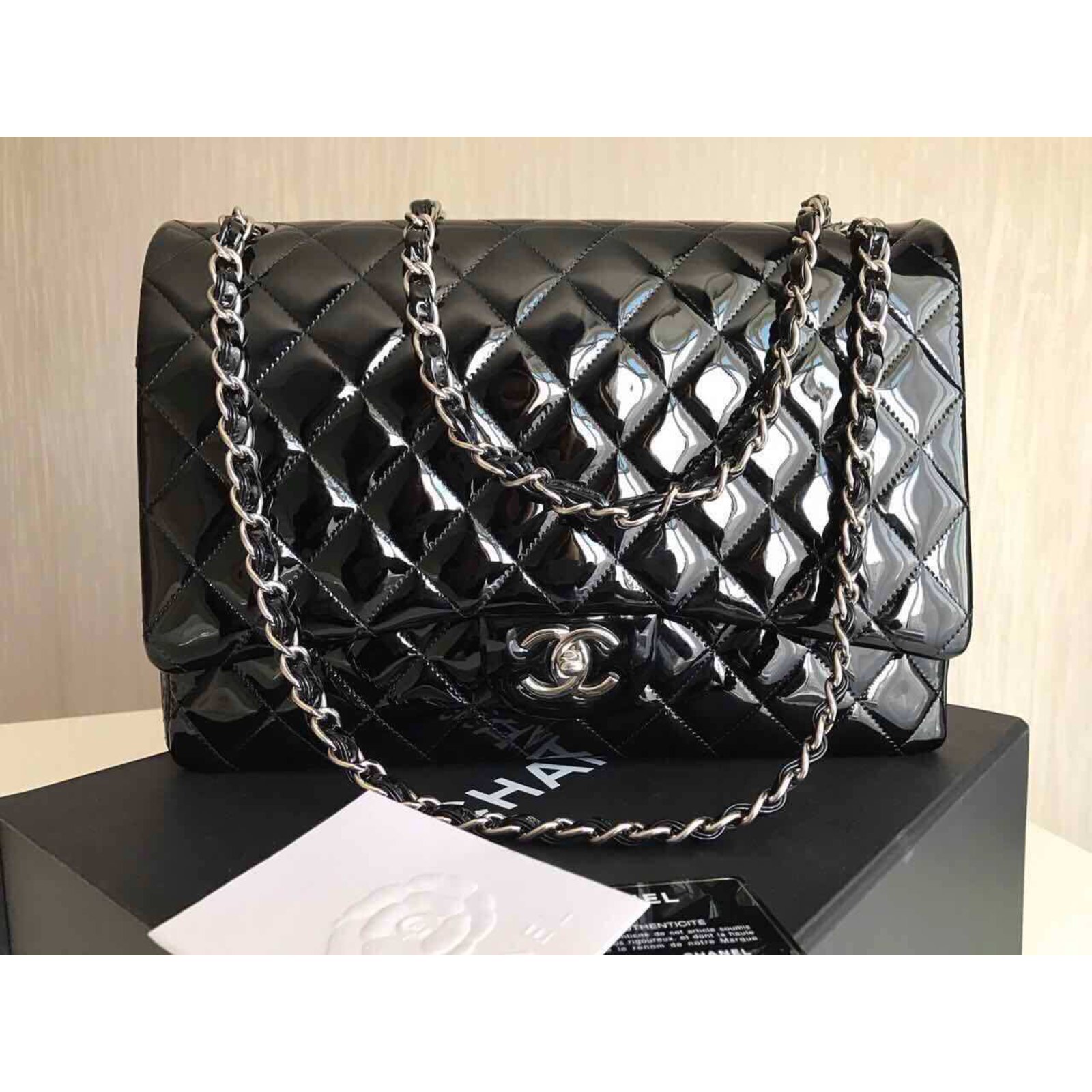 A BLACK PATENT LEATHER CHAIN AROUND MAXI FLAP BAG WITH GOLD HARDWARE