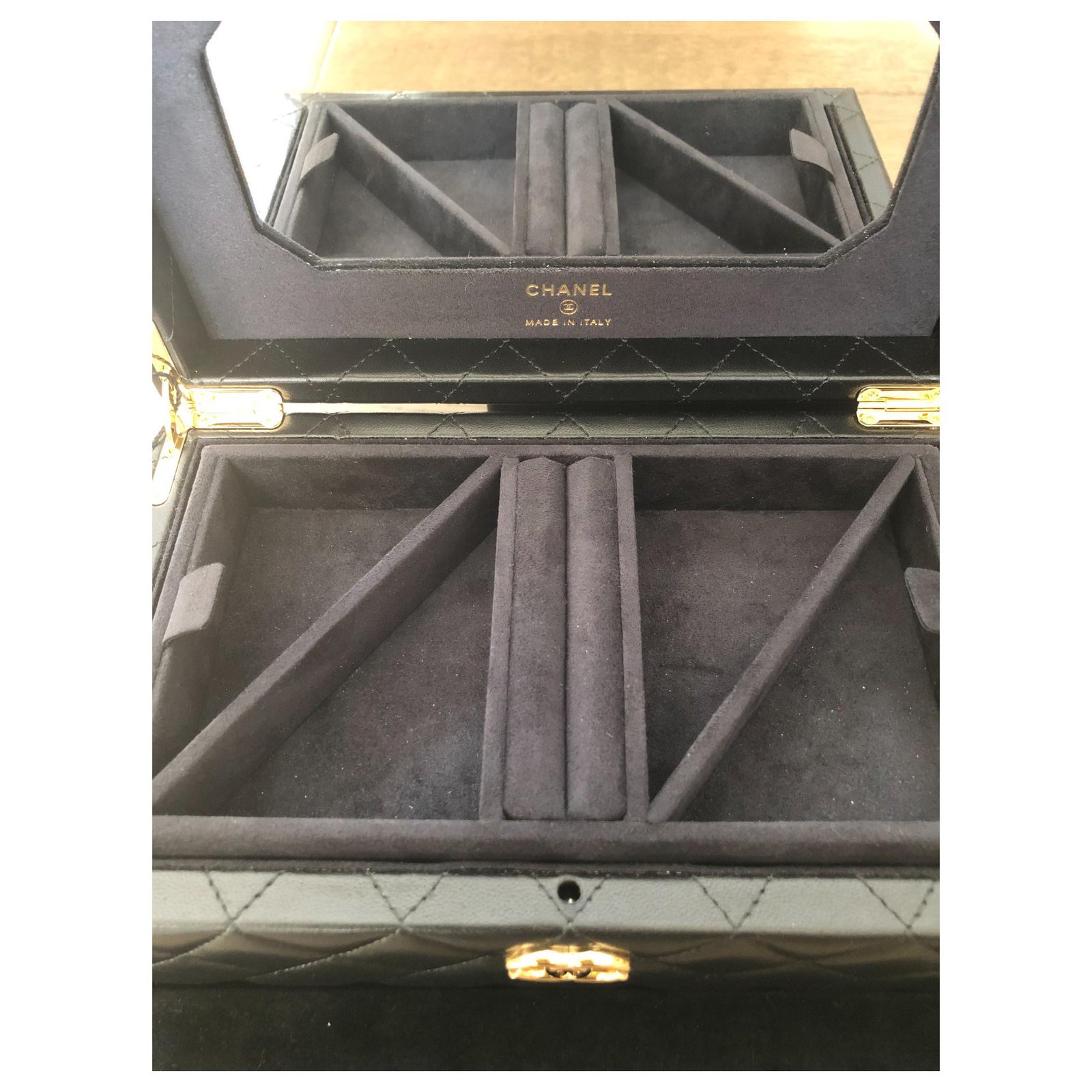 A BLACK LAMBSKIN LEATHER QUILTED JEWELRY BOX WITH GOLD HARDWARE