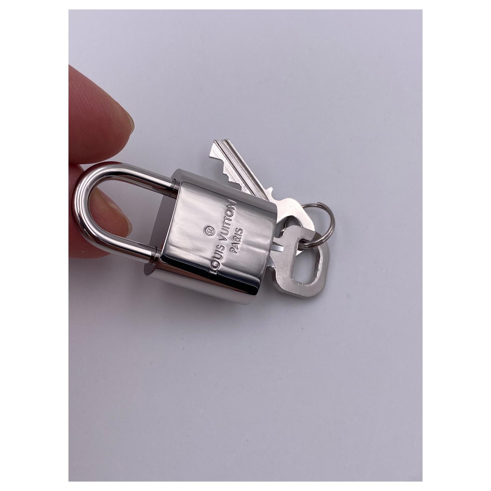 Louis Vuitton Silver Lock and Key Bag Charm Brown Silvery Leather Metal  Pony-style calfskin ref.714586 - Joli Closet