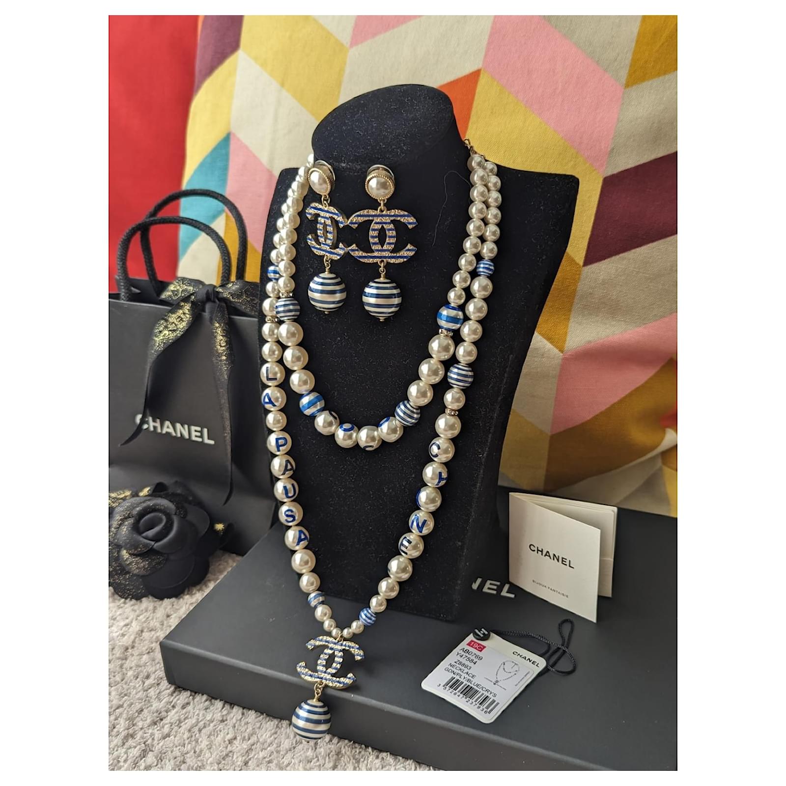 pearl necklace with chanel logo earrings