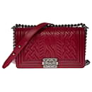 The iconic Chanel Boy old medium limited edition shoulder bag in red embossed leather, ruthenium metal trim