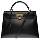 Exceptional Kelly 32 saddle with shoulder strap in black box leather , gold plated metal trim - Hermès