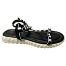 Valentino Garavani Rockstud Ankle Strap Flat Sandals in Black Suede