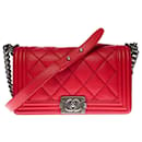 The iconic Chanel Boy old medium shoulder bag in red quilted leather, ruthenium metal trim