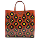 Prada Spazzolato tote bag with geometric flower appliqué design in rust patent leather