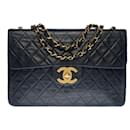 Majestic Chanel Maxi Jumbo single flap bag in black quilted lambskin, gold metal trim