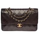 The coveted Chanel Timeless Medium bag 25 cm with lined flap in brown quilted lambskin, garniture en métal doré