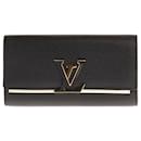 Very beautiful Louis Vuitton Capucines wallet in soft black and pink Taurillon leather