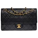 The coveted Chanel Timeless/Classic medium bag 25 cm with lined flap in black quilted lambskin, garniture en métal doré