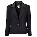 The iconic Chanel suit jacket in black tweed