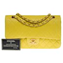 The iconic "Must Have" Chanel Timeless medium bag 25 cm Two-tone limited edition with lined flap in yellow quilted lambskin