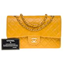The iconic “Must have” Chanel Timeless medium bag 25 cm with lined flap in ocher yellow quilted lambskin,
