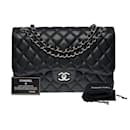 Splendid Chanel Timeless Jumbo lined flap handbag in black quilted caviar leather