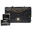 The iconic “Must have” Chanel Timeless medium bag 25 cm with lined flap in black quilted lambskin